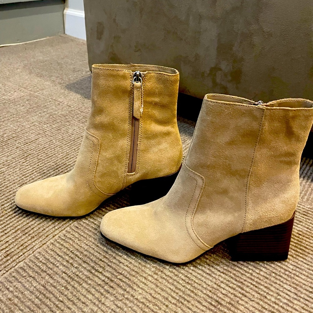 Cream colored suede, heeled boots.